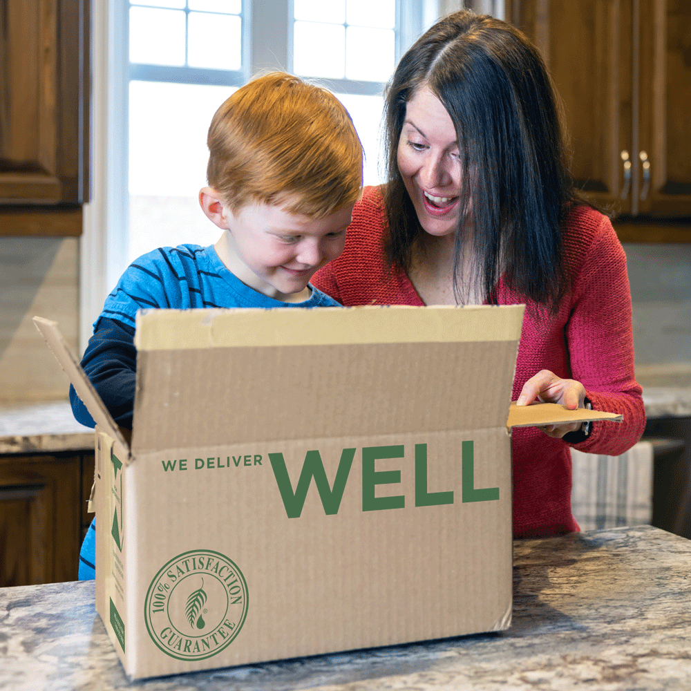 Melaleuca delivery being opened by a son and mom