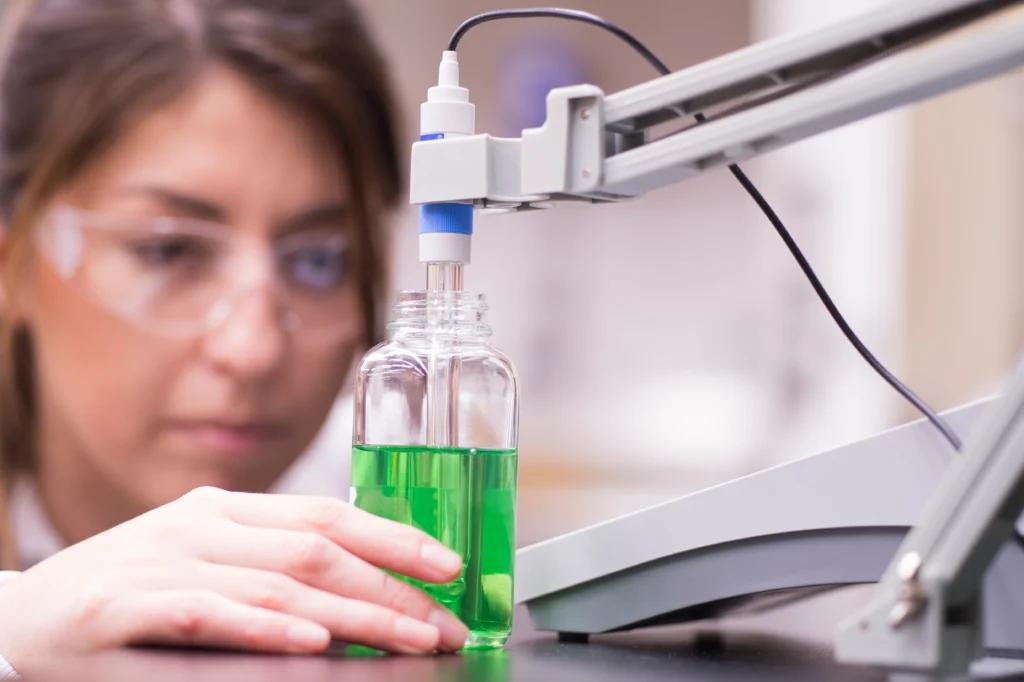 a female scientist examining a bottle of liquid
