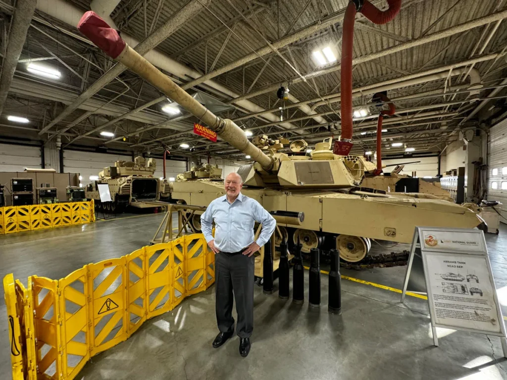 Frank in front of a battle tank.